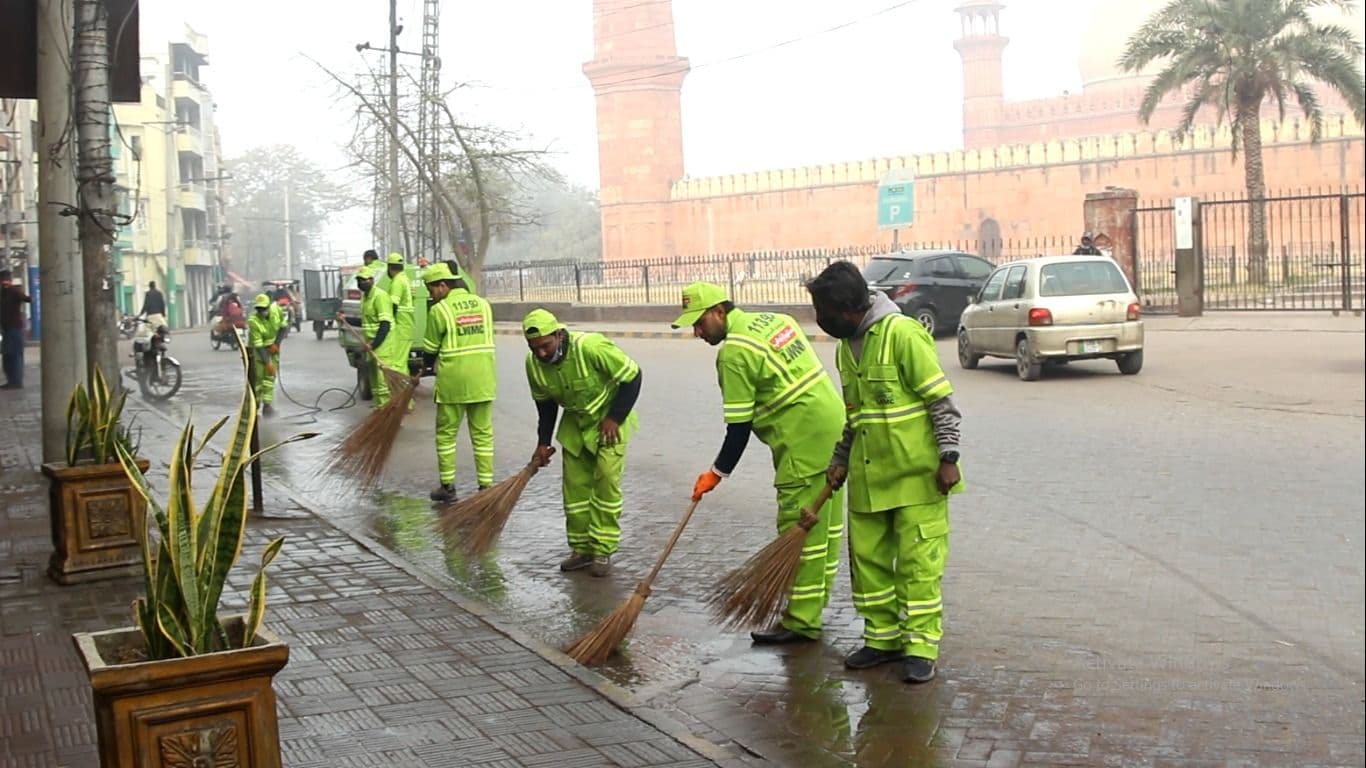 workers cleaning near badshahi mosque