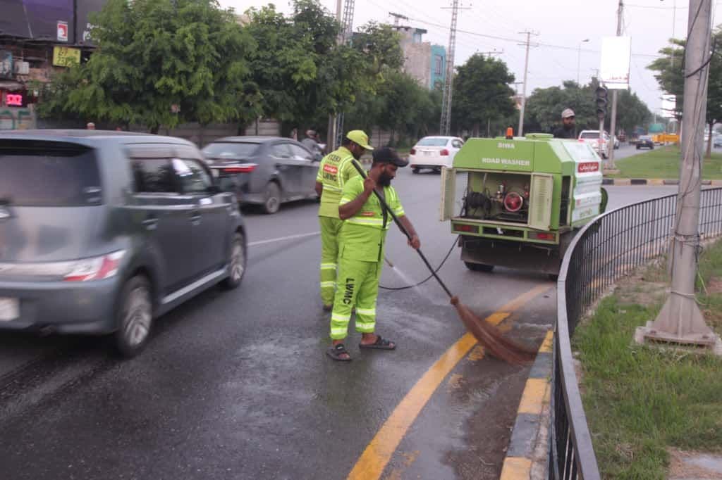 workers cleaning a road